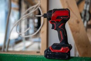 Cordless Power Drill on Green Surface at Construction Site photo