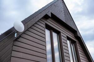 Modern Private House with Dark Wooden Siding and Wi Fi Router photo