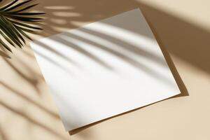 Blank white paper mockup on beige background with tropical palm leaf shadows in minimal natural sunlight scene for branding or design presentation photo