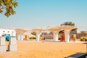 A playground with a structure made of white fabric photo