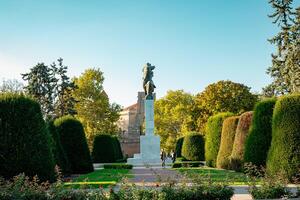 A statue of a man in a garden photo