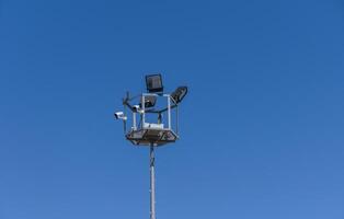 Surveillance tower monitoring the environment under the clear blue sky with modern technology photo