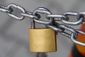 Locked securely, ensuring safety with a sturdy padlock on a chain link, representing protection in an urban environment photo