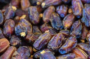 Discovering the rich textures and colors of fresh dates at a vibrant market in the heart of the desert photo