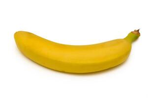 Bright yellow banana resting on a clean surface perfect for a healthy snack or smoothie addition in a kitchen setting photo