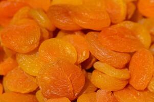 Dried apricots arranged in a colorful display showcasing their vibrant hues and natural texture during an artisanal market event photo