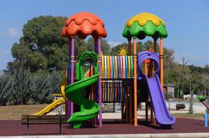 Vibrant playground structure invites children for adventure and imaginative play in a sunny park setting photo