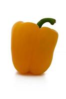 Bright yellow bell pepper stands out against a clean white background, showcasing its vibrant color and natural shine in a minimalist setting photo