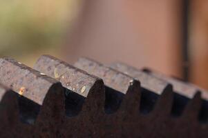 Intricately designed metal gears catching sunlight in a rustic workshop during the late afternoon photo