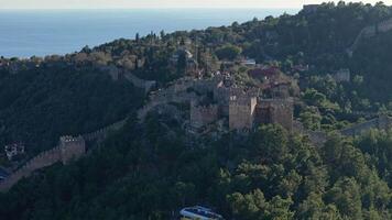 Aerial view of an ancient fortress with walls extending across hills video