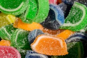 Colorful gummy candies sprinkled with sugar create a vibrant and tempting display of sweetness and joy in a delightful treat photo