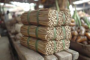 Bundles of Dried Plant Stalks at a Rustic Market Setting for Natural Crafts photo