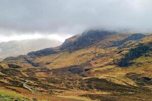 Dramatic Foggy Mountain Landscape with Rolling Hills in Moody Weather photo