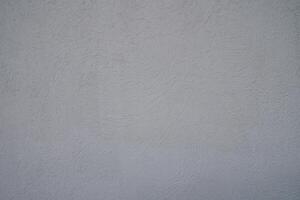 Textured gray wall with subtle nuances captured during early afternoon light photo