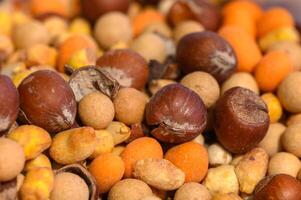 Colorful assortment of nuts and seeds creates a vibrant display in a local market setting photo