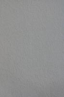 Textured plaster wall exhibiting subtle color variations under natural light, creating a soft and calming atmosphere photo