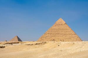 reat Sphinx and Great Pyramid of Cheops, Cairo, Egypt. Ancient statue of Sphinx, mythical creature with head of man and body of a lion Giza pyramid complex Giza Necropolis photo