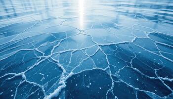 close up of the cracked ice background with a bluish-gray tint and transparent areas. The network of cracks creates a unique pattern that highlights the frosty beauty of winter nature. photo