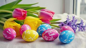 Bright Easter eggs with floral patterns on the background of a bouquet of tulips and hyacinths create a joyful atmosphere of spring and celebration, filling the space with happiness and fun photo