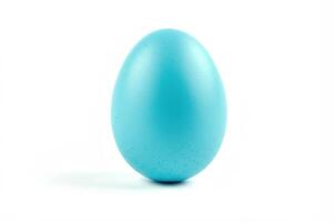 a blue egg on a pure white background, creating an atmosphere of minimalism and tranquility. The simplicity of the composition focuses on color and shape. photo