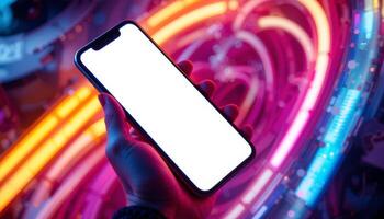 A smartphone held in a hand against a colorful, illuminated background, emphasizing technology and modernity with a blank screen. photo