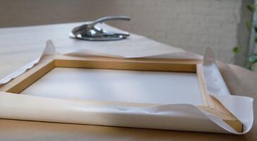 Canvas framing. Stretching canvas on stretcher frame. Gallery wrap photo