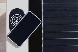 Bench with solar panel, powered by sunlight, and place for charging mobile phone at the quay of Split, Croatia. Concept of clean energy and wireless technologies photo
