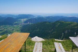 Tables and benches for relaxation, cafe or picnic with a mountain view of Puchberg am Schneeberg, Austrian Alps. Alpine scenery photo