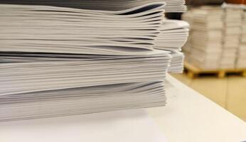 Close-up, a stack of glued book blocks prepared for binding in a printing house, vertical. photo