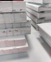 A stack of books on a table with a white background photo