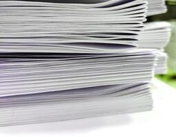 Close-up, a stack of glued book blocks prepared for binding in a printing house photo