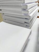 A stack of white paper on a table photo