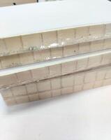 Close-up, a stack of glued book blocks prepared for binding in printing house, vertical. photo