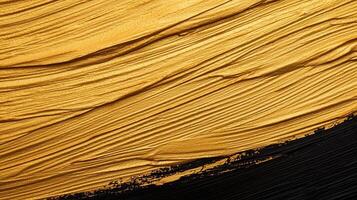Golden paint brush stroke splashing across dark surface, representing artistic elegance and luxurious graphic design photo
