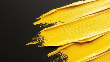 Golden paint brush stroke splashing across elegance surface, representing artistic dark and luxurious graphic design element photo
