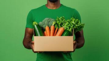 Delivery person cardboard box with fresh organic produce for home delivery photo