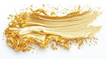 Gold artistic brush paint sweeping across white surface, revealing metallic strokes texture photo