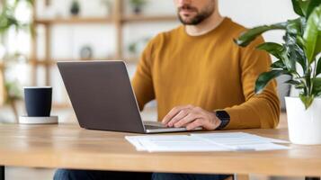 freelancer man wearing headphones using laptop and mobile smart phone while working from home in his and modern cozy home office with plants and natural light photo