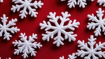 Delicate shimmering drifting against sparkle red surface, highlighting winter holiday snowflake photo