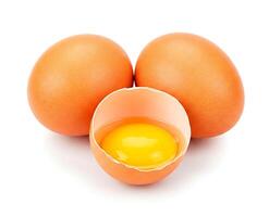 Brown chicken eggs and one broken open egg showing its yolk, isolated on white background photo