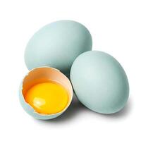 Group of blue araucana chicken eggs and one broken open egg showing its yolk, isolated on white background photo