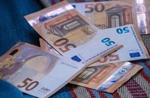 A spread of 50 euro notes showcasing European currency, representing savings, investment, and wealth in a financial or economic context. Closeup image of multiple banknotes. 05 photo