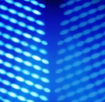 Blurred light spots, shadows from the blinds on the concrete wall, creating creating a glowing effect with a soft, futuristic texture, ideal for backgrounds and creative design. Copy space 02 photo