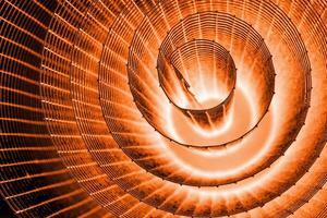 Abstract spiral with glowing red and orange tones and wire texture against a black background, symbolizing energy, motion, industrial and futuristic design concepts. Copy space 01 photo