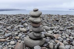 Balancing stones creating a zen atmosphere on a pebble beach in Iceland photo