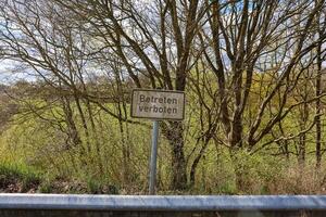 No trespassing sign near a green field in Germany photo