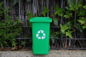 Green recycling bin on nature, eco container, recycle concept photo