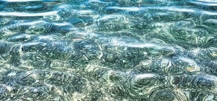 texture of sea water, transparent sea like the Caribbean on a hot Italian summer day photo