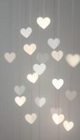 Glowing Hearts Cascade Abstract Vertical Display of Heart-Shaped Lights photo