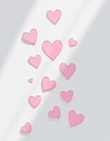 A collection of pink hearts floating down on a white background with shadows and sunlight photo